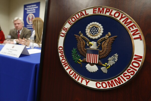 The emblem of the U.S. Equal Employment Opportunity Commission (EEOC) is shown on a podium in Vail, Colorado, Feb. 16, 2016, in Denver. (AP Photo/David Zalubowski, File)