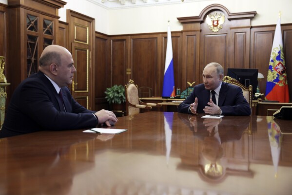 Russian President Vladimir Putin, right, speaks to Mikhail Mishustin, the candidate for the post of Russian Prime Minister during their meeting at the Kremlin in Moscow, Russia, Friday, May 10, 2024. (Gavriil Grigorov, Sputnik, Kremlin Pool Photo via AP)