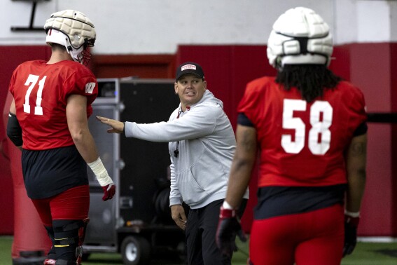 Wisconsin offensive line coach AJ Blazek speaks to his players during NCAA college spring football practice at the McClain Center in Madison, Wis., Tuesday, April 9, 2024. (Samantha Madar/Wisconsin State Journal via AP)
