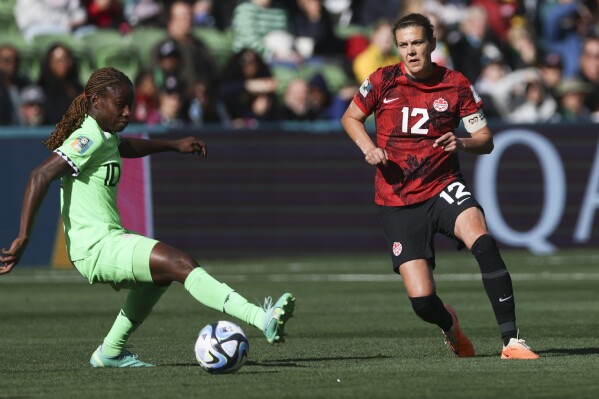 Nigeria's Christy Ucheibe, left, and Canada's Christine Sinclair compete for the ball during the Women's World Cup Group B soccer match between Nigeria and Canada in Melbourne, Australia, Friday, July 21, 2023. (AP Photo/Hamish Blair)