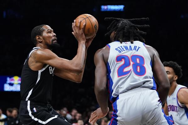 Brooklyn Nets' Kevin Durant, left, shoots over Detroit Pistons' Isaiah Stewart during the second half of an NBA basketball game Tuesday, March 29, 2022 in New York. The Nets won 130-123. (AP Photo/Frank Franklin II)