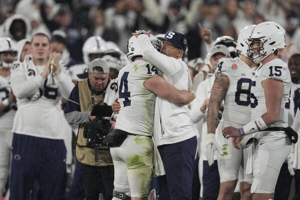 Penn State quarterback Sean Clifford (14) is hugged by Penn State head coach James Franklin during the second half in the Rose Bowl NCAA college football game against Utah Monday, Jan. 2, 2023, in Pasadena, Calif. (AP Photo/Mark J. Terrill)