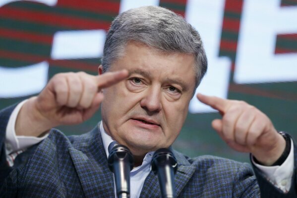 
              Ukrainian President Petro Poroshenko gestures while speaking at his headquarters after the presidential election in Kiev, Ukraine, Sunday, March 31, 2019. The exit poll released Sunday after voting stations closed indicated that Zelenskiy received about 30.4 percent of the nationwide vote, followed by incumbent President Petro Poroshenko with 17.8 percent and former Prime Minister Yulia Tymoshenko with 14.2 percent support. (AP Photo/Efrem Lukatsky)
            