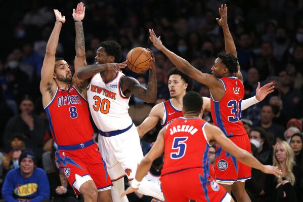 New York Knicks forward Julius Randle (30) looks for help as Detroit Pistons' Trey Lyles (8), Cade Cunningham, Frank Jackson (5) and Saben Lee (38) defend during the first half of an NBA basketball game Tuesday, Dec. 21, 2021, in New York. (AP Photo/Noah K. Murray)
