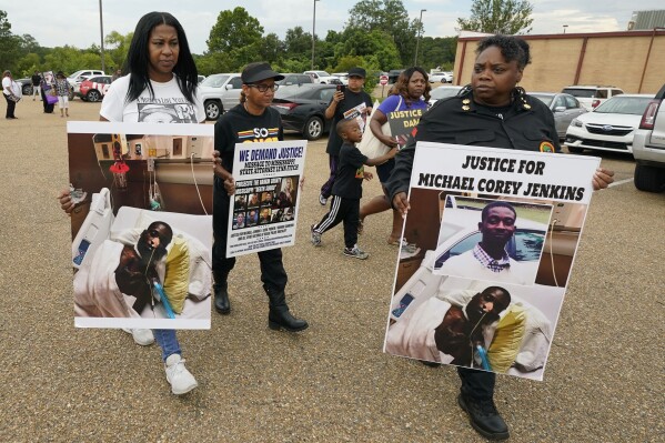 FILE - Activists march towards the Rankin County Sheriff's Office in Brandon, Miss., Wednesday, July 5, 2023, calling for the termination and prosecution of Rankin County Sheriff Bryan Bailey for running a law enforcement department that allegedly terrorizes and brutalizes minorities. Six white former law enforcement officers in Mississippi have pleaded guilty to a racist assault on Michael Corey Jenkins and his friend Eddie Terrell Parker, who are Black. (AP Photo/Rogelio V. Solis, File)