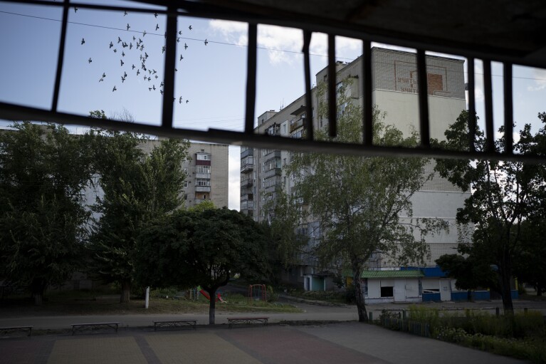 Birds are flying over a flat in Kupiansk, Ukraine, Wednesday, Aug. 23, 2023. (AP Photo/Bram Janssen)