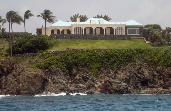 This Tuesday, July 9, 2019 photo shows a structure on Little Saint James Island, in the U. S. Virgin Islands. Locals recalled seeing Jeffery Epstein's black helicopter flying back and forth from the international airport in St. Thomas to his helipad on Little St. James Island, where he built a cream colored mansion with a bright turquoise roof surrounded by several other structures including the maids' quarters and a massive, square-shaped white building on one end of the island that some say is a music room fitted with acoustic walls. (AP Photo/Gianfranco Gaglione)