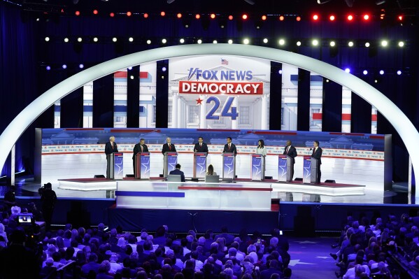 FILE - Republican presidential candidates, from left, former Arkansas Gov. Asa Hutchinson, former New Jersey Gov. Chris Christie, former Vice President Mike Pence, Florida Gov. Ron DeSantis, businessman Vivek Ramaswamy, former U.N. Ambassador Nikki Haley, Sen. Tim Scott, R-S.C., and North Dakota Gov. Doug Burgum stand at their podiums during a Republican presidential primary debate hosted by FOX News Channel Wednesday, Aug. 23, 2023, in Milwaukee. (AP Photo/Morry Gash, File)