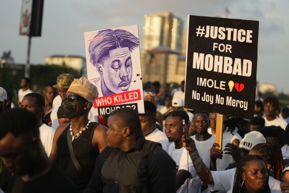 People chant slogans during a protest on the streets of Lagos, Nigeria, Thursday, Sept. 21, 2023, to demand justice following the mysterious death of Afrobeat star Mohbad. Lagos police said the body of the late Ilerioluwa Aloba, better known as MohBad, was exhumed Thursday afternoon in response to complaints about the unclear circumstances surrounding his death. (AP Photo/Sunday Alamba)