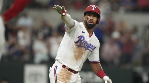 Texas Rangers Ezequiel Duran gestures towards his dugout after hitting a solo home run during the eighth inning of a baseball game against the Detroit Tigers in Arlington, Texas, Tuesday, June 27, 2023. (AP Photo/LM Otero)