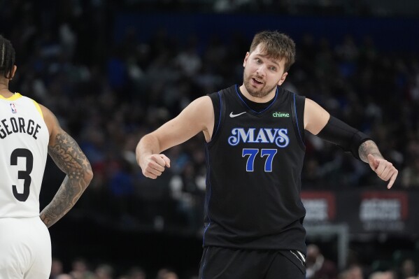 Dallas Mavericks guard Luka Doncic (77) reacts after a call as Utah Jazz guard Keyonte George (3) looks on during the second half of an NBA basketball game in Dallas, Thursday, March 21, 2024. (AP Photo/LM Otero)