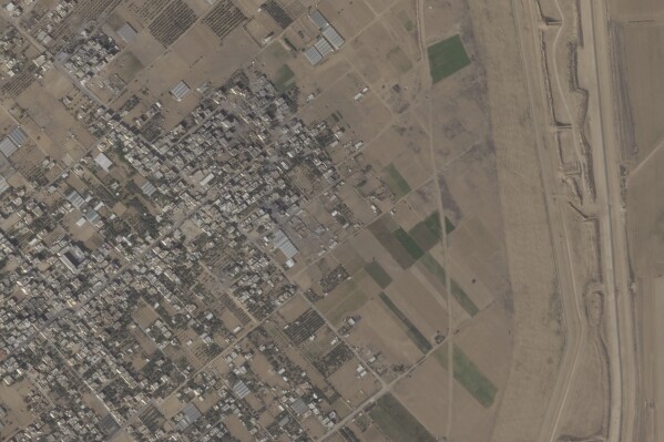 This satellite photo from Planet Labs PBC shows the town of Khuzaa, east of Khan Younis in the southern Gaza Strip in Oct., 2023. (Planet Labs PBC via AP)