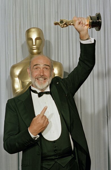 FILE - In this file photo dated April 11, 1988, Sean Connery holds up his best supporting actor Oscar for "The Untouchables" at the 60th annual Academy Awards in Los Angeles, Ca., USA.  Scottish actor Sean Connery, considered by many to have been the best James Bond, has died aged 90, according to an announcement from his family. (AP Photo/Lennox McLendon, FILE)