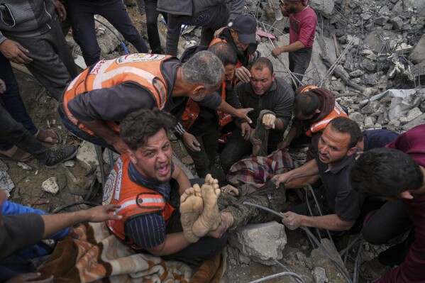 The body of a man is recovered from the rubble of the Manoun family's house after it was hit by an Israeli army strike in Jabalia al-Balad, Gaza City, April 13, 2025. (AP Photo/Jehad Alshrafi)