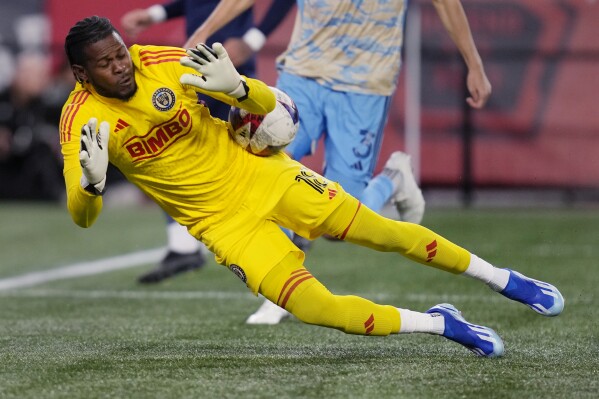 Philadelphia Union goalkeeper Andre Blake makes a save against the New England Revolution during the first half of an MLS playoff soccer game, Wednesday, Oct. 8, 2023, in Foxborough, Mass. (AP Photo/Charles Krupa)