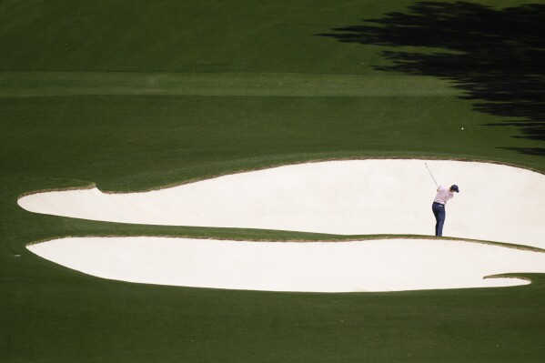 Rory McIlroy, of Northern Ireland, hits from the bunker on the eighth hole during third round at the Masters golf tournament at Augusta National Golf Club Saturday, April 13, 2024, in Augusta, Ga. (AP Photo/Charlie Riedel)
