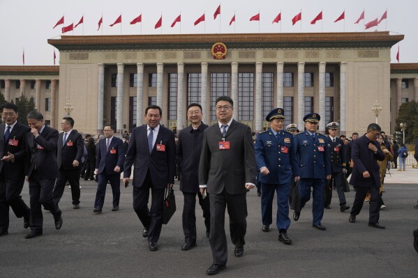 Delegates leave after a preparatory session of the National People's Congress outside the Great Hall of the People in Beijing, Monday, March 4, 2024. (AP Photo/Ng Han Guan)