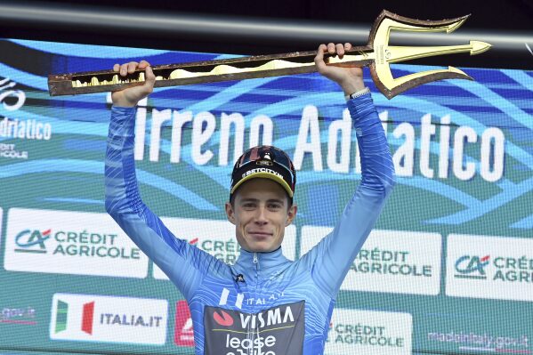 Jonas Hansen Vingegaard - Team Visma - Lease A Bike, the winner of the race, celebrates on the podium with the Trident Trophy after the 59th Tirreno - Adriatico 2024, Stage from San Benedetto del Tronto to San Benedetto del Tronto, Sunday, March 10, 2024 in San Benedetto del Tronto, Tuscany, Italy. (FGianmattia D'Alberto/LaPresse via AP)