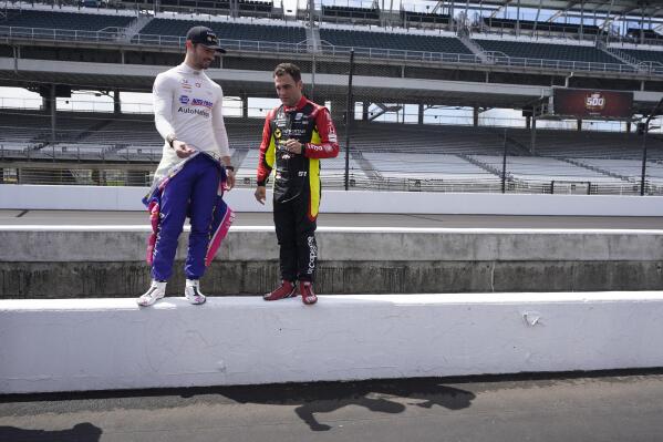 Alexander Rossi, left, and Delvin Defrancesco look at pit lane before testing at Indianapolis Motor Speedway, Thursday, April 21, 2022, in Indianapolis. (AP Photo/Darron Cummings)