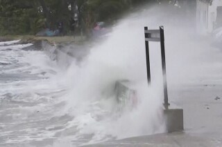 In this image made from video provided by AubC, waves hit a coastline in Bowen, Australia, Thursday, Jan. 25, 2024. Strong winds hit Australia’s northeast coast Friday, leaving thousands without power, but the area was spared heavy damage as Tropical Cyclone Kirrily weakened into a tropical storm. (AuBC via AP)