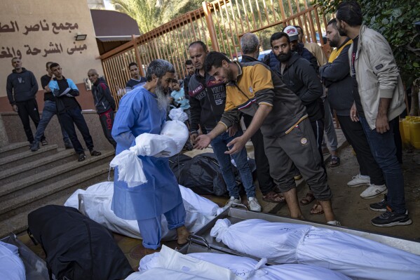 Palestinians mourn their relatives killed in the Israeli bombardment of the Gaza Strip, in the hospital in Khan Younis, Saturday, Nov. 18, 2023. (AP Photo/Fatima Shbair)