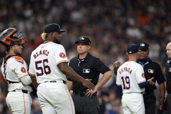 Houston Astros starting pitcher Ronel Blanco (56) talks with second base umpire Tripp Gibson after being ejected following a foreign substance check during the fourth inning of a baseball game against the Oakland Athletics Tuesday, May 14, 2024, in Houston. (AP Photo/David J. Phillip)