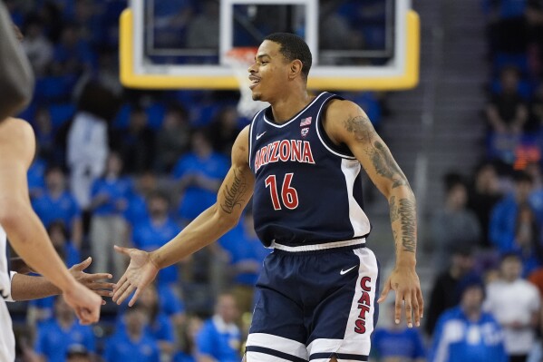 Arizona forward Keshad Johnson (16) celebrates his basket during the first half of an NCAA college basketball game against UCLA in Los Angeles, Thursday, March 7, 2024. (AP Photo/Jae C. Hong)