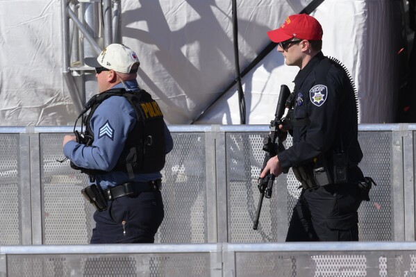 Law enforcement personnel arrive to investigate following a shooting at the Kansas City Chiefs NFL football Super Bowl celebration in Kansas City, Mo., Wednesday, Feb. 14, 2024. Multiple people were injured, a fire official said.(AP Photo/Reed Hoffmann)