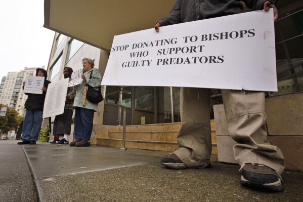 FILE - Members of SNAP (the Survivors Network of those Abused by Priests) hold up signs during a demonstration in front of the archdiocese headquarters in San Francisco, March 29, 2010. San Francisco's Roman Catholic archdiocese filed for bankruptcy Monday, Aug. 21, 2023, saying the filing is necessary to manage more than 500 lawsuits alleging child sexual abuse by church officials. (AP Photo/Paul Sakuma, File)
