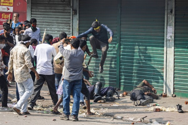 Activists of the the opposition Bangladesh Nationalist Party attack security officers during a protest in Dhaka, Bangladesh, Saturday, Oct. 28, 2023. The protestors demanded the resignation of Prime Minister Sheikh Hasina and the transfer of power to a non-partisan caretaker government to oversee general elections next year. (AP Photo/Mahmud Hossain Opu)