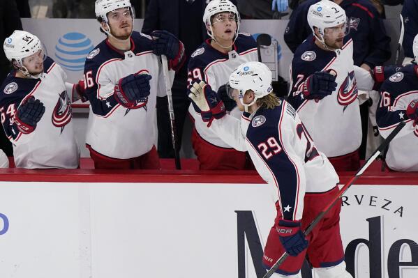 Columbus Blue Jackets left wing Patrik Laine (29) celebrates with teammates after scoring against the Chicago Blackhawks during the third period of an NHL hockey game in Chicago, Thursday, Feb. 17, 2022. (AP Photo/Nam Y. Huh)