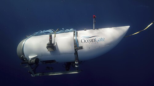 FILE - This image provided by OceanGate Expeditions shows a submersible vessel called the Titan being used to visit the site of the Titanic wreck.  The wreckage of the Titanic and Titan lie at the bottom of the ocean, separated by 1,600 feet (490 meters) and 111 years of history.  She unfolded how they came together over the course of an intense week that sparked tentative hopes and left lingering questions.  (OceanGate trips via AP, file)
