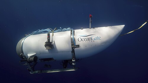 FILE - This image provided by OceanGate Expeditions shows a submersible vessel called the Titan being used to visit the site of the Titanic wreck.  The wreckage of the Titanic and Titan lie at the bottom of the ocean, separated by 1,600 feet (490 meters) and 111 years of history.  She unfolded how they came together over the course of an intense week that sparked tentative hopes and left lingering questions.  (OceanGate Trips via AP, file)