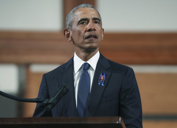 FILE - In this July 30, 2020 file photo, former President Barack Obama, addresses the service during the funeral for the late Rep. John Lewis, D-Ga., at Ebenezer Baptist Church in Atlanta. Obama is endorsing Rev. Raphael Warnock in the race to fill a U.S. Senate seat in Georgia. Warnock is one of the Democrats running in a crowded field for the special election to be held Nov. 3. The seat is currently held by Republican Kelly Loeffler, a wealthy businesswoman who was appointed earlier this year by Republican Gov. Brian Kemp. (Alyssa Pointer/Atlanta Journal-Constitution via AP, Pool, File)