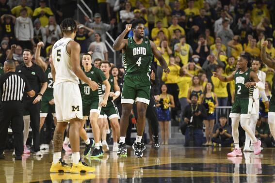 Ohio forward Dwight Wilson III (4) reacts after scoring as time expired in the second half of an NCAA college basketball game to send it into overtime against Michigan, Sunday, Nov. 20, 2022, in Ann Arbor, Mich. (AP Photo/Jose Juarez)