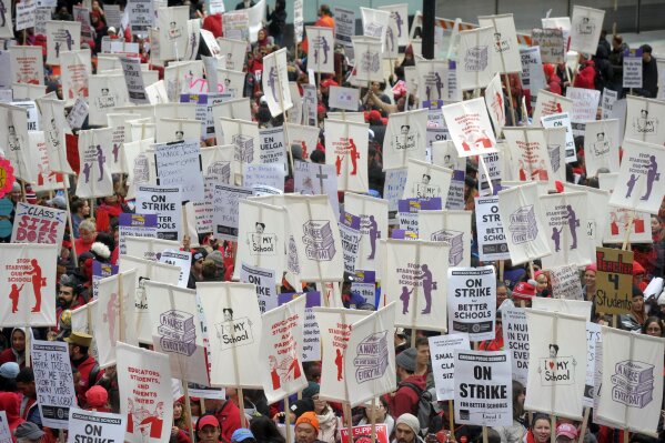 Thousands of teachers, teacher's union members, and supporters gathered near the Chicago Public School headquarters and march on the streets in downtown Chicago, Thursday, Oct. 17, 2019. The strike in the nation's third-largest school district came after the Chicago Teachers Union confirmed Wednesday night that its 25,000 members would not return to their classrooms. (Victor Hilitski/Chicago Sun-Times via AP)