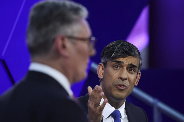 Britain's Prime Minister Rishi Sunak and opposition Labour Party leader Keir Starmer, left, take part for the BBC's Prime Ministerial Debate, in Nottingham, England, Wednesday June 26, 2024. (Phil Noble/Pool via AP)