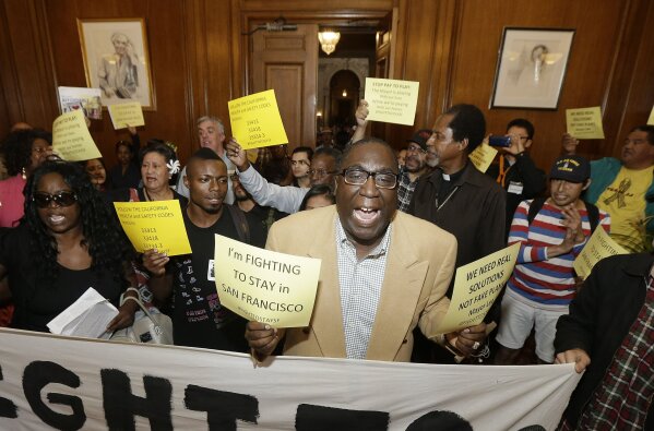 
              FILE - In this Oct. 20, 2015, file photo, Pastor Yul Dorn, center, who is faced eviction due to foreclosure, yells as he and others protest evictions in Mayor Ed Lee's office at City Hall in San Francisco. Dorn and his wife expect to join the growing ranks of African-Americans who do not own their homes, a rate that was nearly 30 percentage points higher than that of whites in 2016, according to a report by Harvard University's Joint Center for Housing Studies. (AP Photo/Jeff Chiu, File)
            
