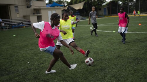 Teenage girls play soccer at the Union School in Port-au-Prince, Haiti, Monday, June 5, 2023. The school's soccer program aims to keep kids off the street and prevent them from joining gangs, as well as potentially recruit the next big stars. (AP Photo/Ariana Cubillos)