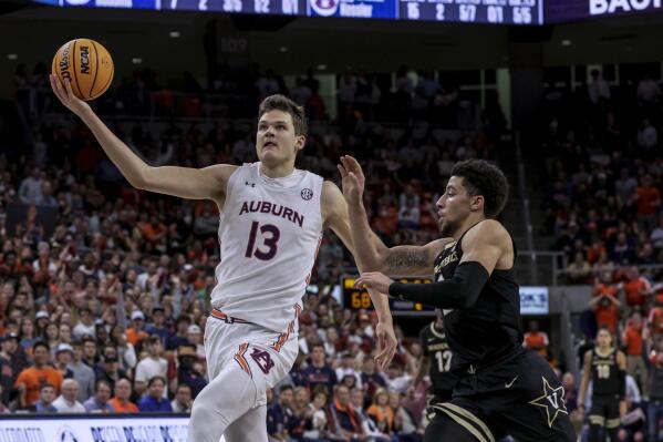 Auburn forward Walker Kessler (13) goes up for a layup as Vanderbilt guard Scotty Pippen Jr. defends during the second half of an NCAA college basketball game Wednesday, Feb. 16, 2022, in Auburn, Ala. (AP Photo/Butch Dill)