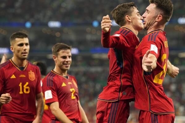 Spain's Gavi, second right, celebrates with Aymeric Laporte after scoring his side's fifth goal during the World Cup group E soccer match between Spain and Costa Rica, at the Al Thumama Stadium in Doha, Qatar, Wednesday, Nov. 23, 2022. (AP Photo/Pavel Golovkin)