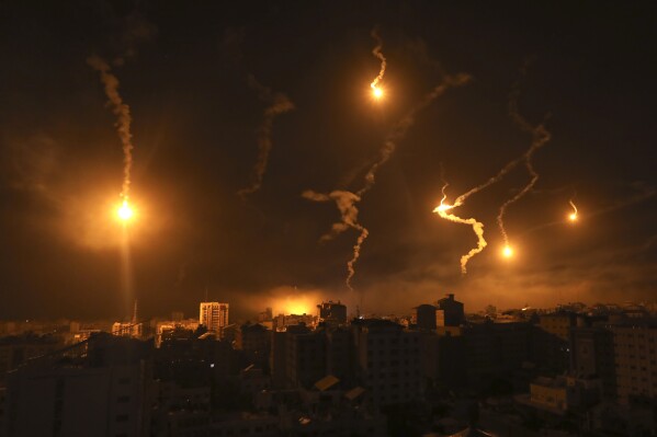 Flares fired by Israeli forces light up the night sky in Gaza City, Monday, Nov. 6, 2023. (AP Photo/Abed Khaled)