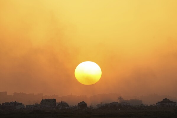 The sun sets over the Gaza Strip as seen from southern Israel, Monday, March 4, 2024. (AP Photo/Ohad Zwigenberg)