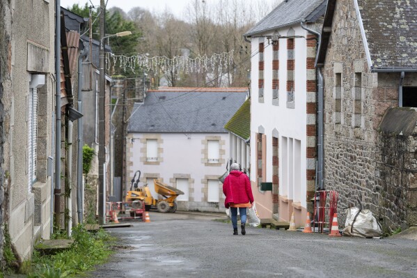 A woman walks down a street in the village of Callac, on Dec.15, 2023. The far right cried victory in January 2023, when mayor Jean-Yves Rolland of Callac gave up his plan to house seven to 10 refugee families. (APPhoto/Mathieu Pattier)