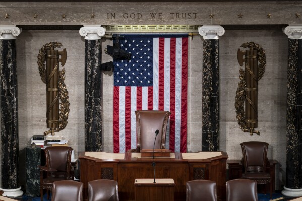 FILE - The speaker's dais is seen in the House of Representatives of the Capitol in Washington, Monday, Feb. 28, 2022. After House Speaker Kevin McCarthy was voted out of the job by a contingent of hard-right conservatives this week, House GOP leaders are now grappling to find a new speaker. With no speaker of the House, a constitutional officer second in line to the presidency, the Congress cannot fully function — to pass laws, fund the government and otherwise serve as the branch of government closest to the people — during a time of simmering uncertainty at home and abroad. (AP Photo/J. Scott Applewhite, File)