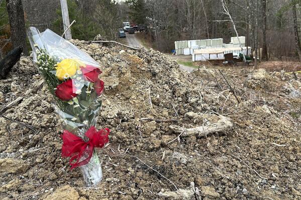 A lone bouquet of flowers marks a desolate makeshift memorial at the end of a driveway at a Bowdoin, Maine, home, Wednesday, April 19, 2023, where police say four people were killed. A Maine man who police say killed four people in a home and then shot three others randomly on a busy highway had been released days earlier from prison, a state official said Wednesday. (AP Photo/Rodrique Ngowi)