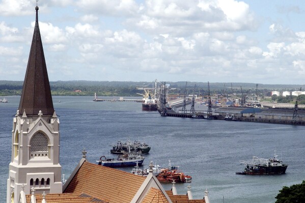 FILE - The Dar es Salaam Port can be seen with the St. Joseph's cathedral in the foreground, on May 22, 2006. Tanzania's government signed a controversial port management deal with Dubai-based DP World that had fueled protests in the African country in the past months and led to arrests of dozens of critics. The deal was signed on Sunday Oct. 22, 2023 in the presence of Tanzania’s President Samia Suluhu Hassan, who has recently been accused of cracking down on critics such as her predecessor, the late John Magufuli. (AP Photo/Khalfan Said, File)