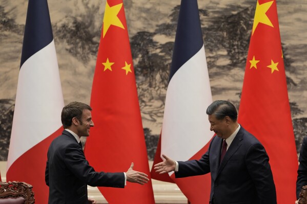 FILE- French President Emmanuel Macron, left, shakes hands with Chinese President Xi Jinping after meeting the press at the Great Hall of the People in Beijing, Thursday, April 6, 2023. Xi will start his Europe tour in Paris on May 6-7, 2024, meeting with Macron, who has been stressing the idea of European strategic autonomy from the U.S. (AP Photo/Ng Han Guan, Pool, File)