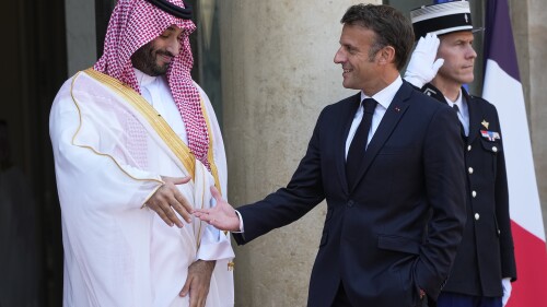 Saudi Crown Prince Mohammed bin Salman prepares to shake hands with French President Emmanuel Macron, Friday, June 16, 2023 at the Elysee Palace in Paris. Saudi Crown Prince Mohammed bin Salman meets Emmanuel Macron as part of an official visit, during which he will also participate in a global financing summit aimed at fighting poverty and climate change. (AP Photo/Michel Euler)