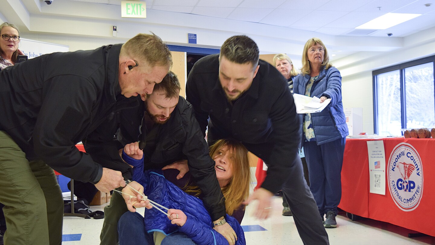 Private security guards charged after woman was dragged out of chaotic Idaho town hall meeting